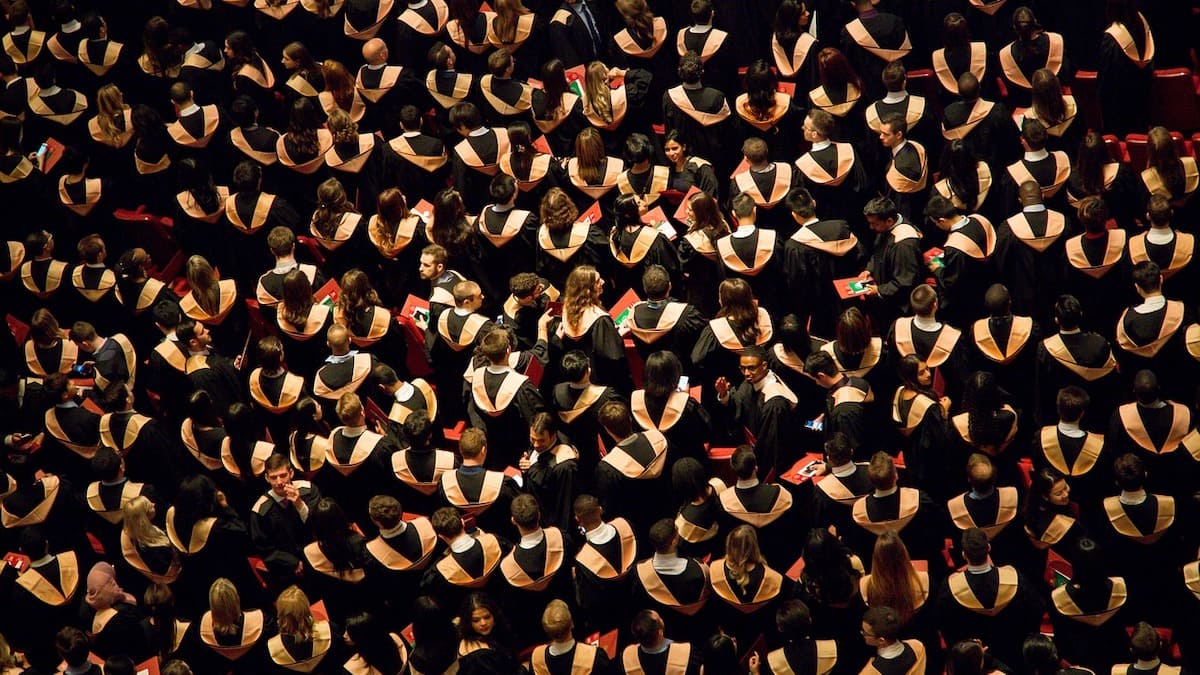 hundreds of students at a graduation ceremony, seen from an aerial view
