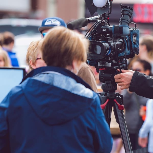 Reporter facing TV camera