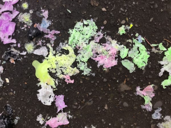 colorful melted wax blobs on the asphalt