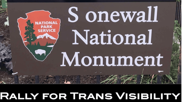 A sign with one letter erased: S onewall National Monument. Rally for trans visibility.